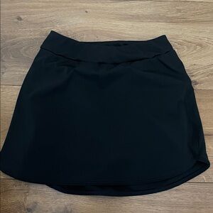 Black spandex, nylon skirt. Tight short with pocket under skirt.